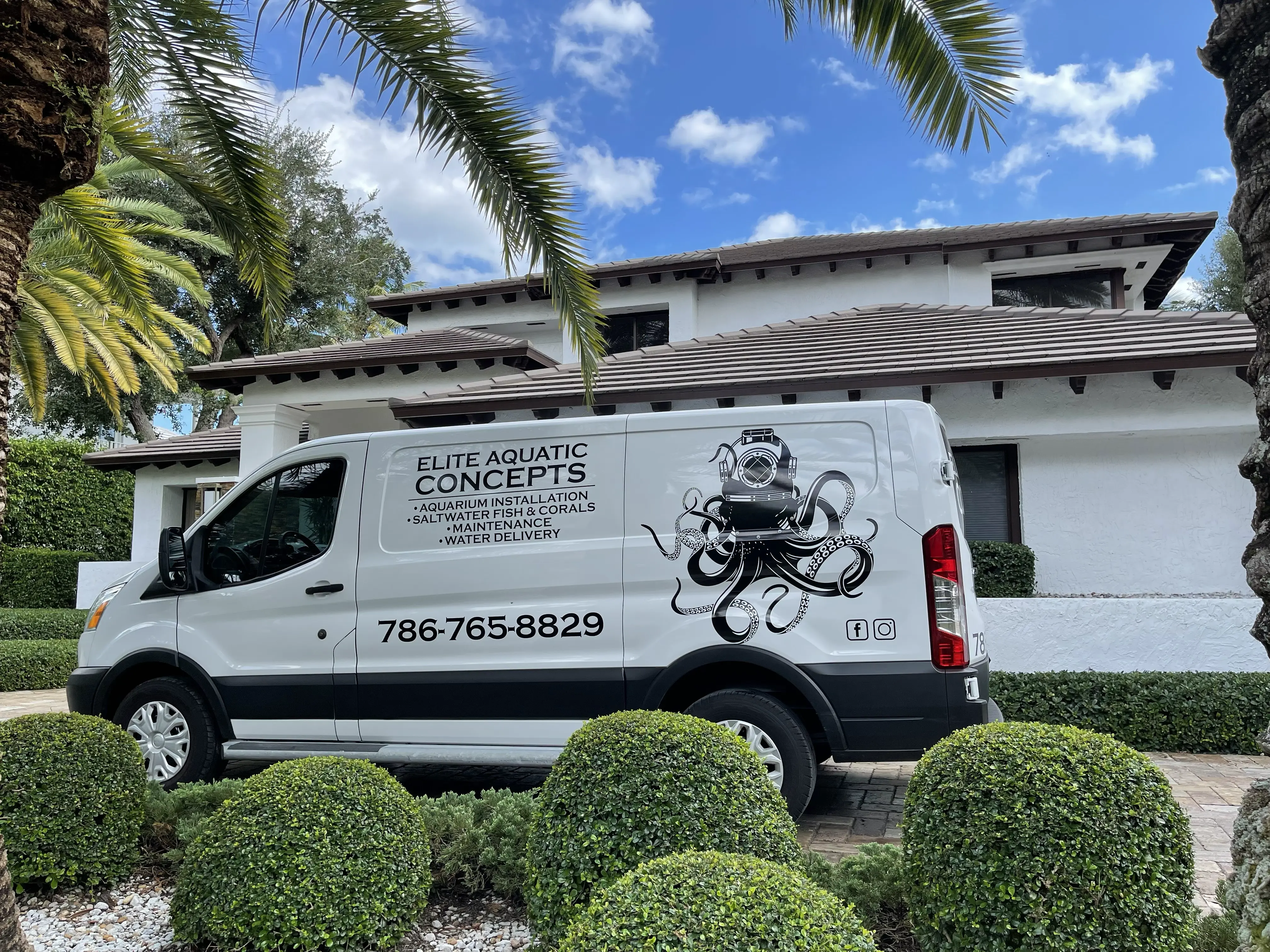 Elite Aquatic Concepts service van parked in a customer's driveway ahead of an aquarium quality assessment